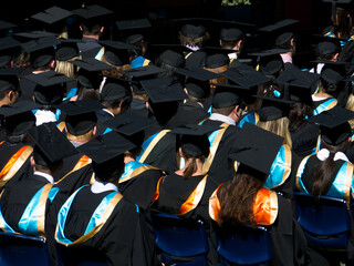 Rear view of student in gowns and mortar boards