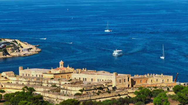 Manoel fort, ships, boats on Mediterranean sea. Malta island