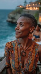 Elegant woman enjoying coastal evening view from luxury resort balcony with glowing lights