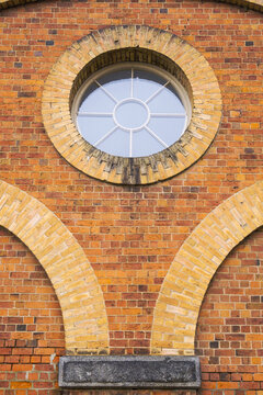 Close up of curved brickwork and circular window