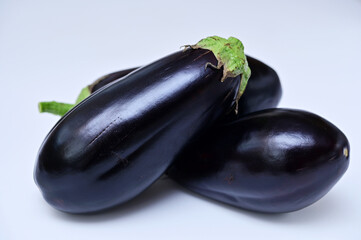 fresh whole eggplants on a white background close-up