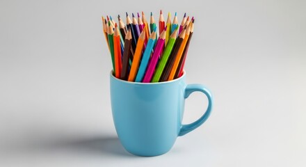 Vibrant colorful wooden pencils neatly arranged in a light blue ceramic mug