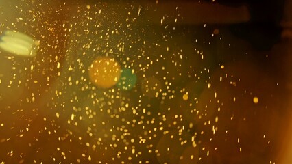 Warm glowing dust particles in golden light