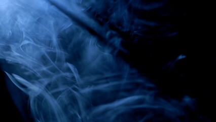 Swirling blue smoke in the dark