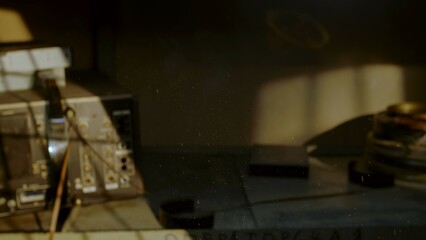 Dust particles in sunbeam over vintage film editing station