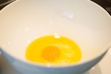Raw egg with olive oil as a base for preparing the cookie dough