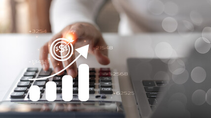 Close-up hand using a calculator with a graph and profit target icon, concept of financial growth,...