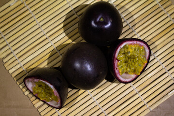 Fresh Passion Fruits Displayed on a Bamboo Mat in Vibrant Composition
