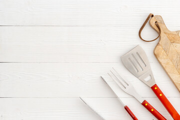 Picnic concept. Barbecue utensils and equipment with cutting board, top view