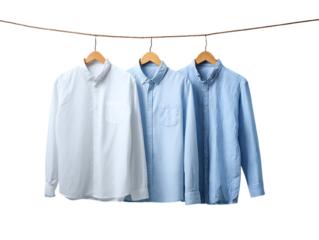 Three Cotton Shirts Hanging on a Pastel Blue Brick Wall on white background