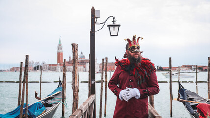 Spectacular masked participant at Venice Carnival near Grand Canal