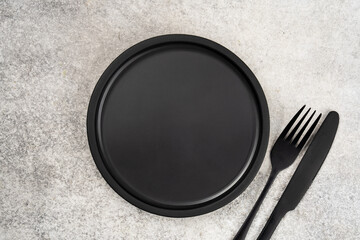 Empty Ceramic Plate on Rustic Stone Table. Minimalist Dining Concept	