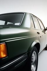 Vintage green coupe with clean lines and minimalist background, retro car design in soft light

