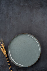 Empty Ceramic Plate on Rustic Stone Table. Minimalist Dining Concept	