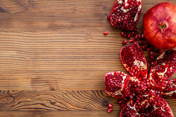 Top view of fresh ripe pomegranate with half and pieces ready for eating