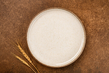 Empty Ceramic Plate on Rustic Stone Table. Minimalist Dining Concept	