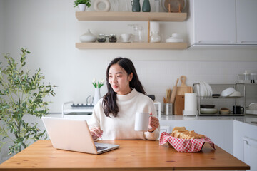 Relaxed work-from-home lifestyle featuring a laptop, coffee mug, and natural light.