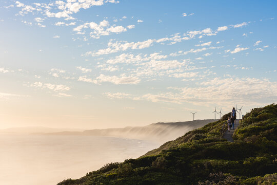 People on walking track at coastal windfarm