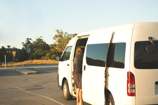 Person standing outside white van in carpark