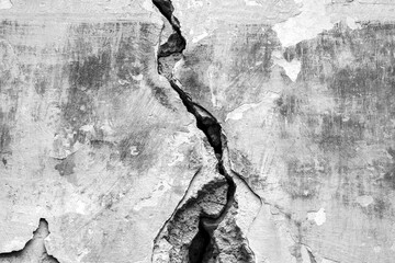 Big deep crack on old wall. Copy space. Close up. Black and white photo