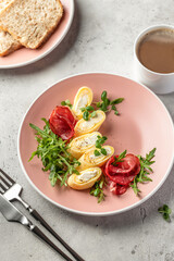 Delicious french omelette stuffed with cheese served with fresh greens and ham. Healthy diet food concept. Protein breakfast