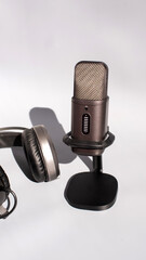 Microphone and headphones set for podcast recording on white background