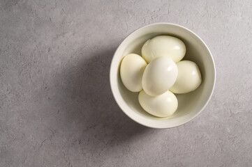 Hard boiled eggs in a bowl, protein food, copy space