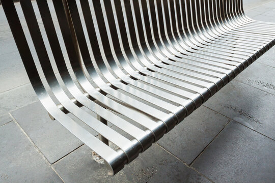 A steel bench on the footpath