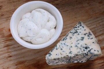 Creamy Dorblu Sauce and Cheese Wedge on Wooden Board as an Aesthetic Accent for Gourmet Recipes and Premium Food Content