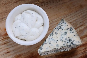 Creamy Dorblu Sauce and Cheese Wedge on Wooden Board as an Aesthetic Accent for Gourmet Recipes and Premium Food Content