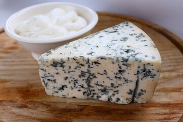 Creamy Dorblu Sauce and Cheese Wedge on Wooden Board as an Aesthetic Accent for Gourmet Recipes and Premium Food Content