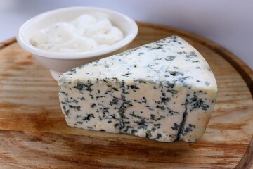 Creamy Dorblu Sauce and Cheese Wedge on Wooden Board as an Aesthetic Accent for Gourmet Recipes and Premium Food Content