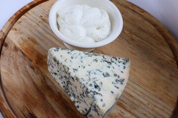 Creamy Dorblu Sauce and Cheese Wedge on Wooden Board as an Aesthetic Accent for Gourmet Recipes and Premium Food Content