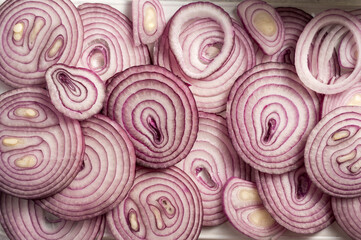 Slices of red onions closeup food background