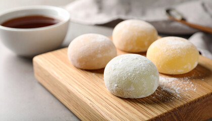 Fototapeta premium Delicious mochi on wooden board. Traditional Japanese dessert. Rice cake. Sweet and tasty food.