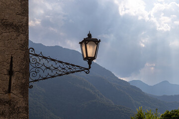 Vintage Street Lantern Against Misty Mountain Landscape with Light Rays