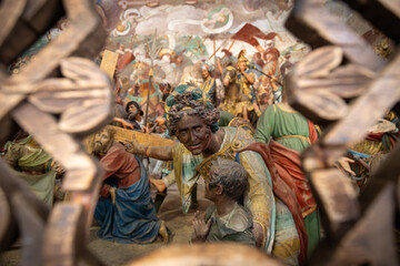 Intricate Religious Scene Featuring Detailed Figures and Ornate Historical Decor