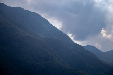 Mountain Range With Cloudy Sky and Dramatic Lighting Effect