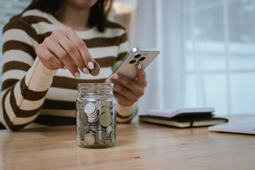 A woman holds a piggy bank, which symbolizes savings, financial planning, and economic challenges....