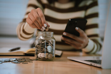 A woman holds a piggy bank, which symbolizes savings, financial planning, and economic challenges....