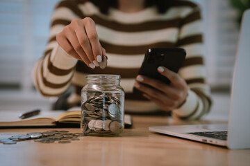 A woman holds a piggy bank, which symbolizes savings, financial planning, and economic challenges....
