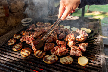 Chicken, pork meat and vegetables cooked on rostil grill, traditional meat dish