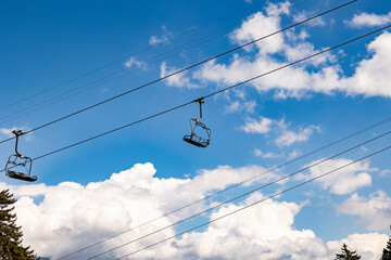 Empty and unoccupied ski lift, Swiss Alps. Switzerland, Canton St. Gallen. Clear sky with clouds,...