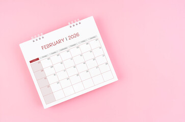 February desk calendar for 2026 year on pink background for schedule to make appointment meeting.