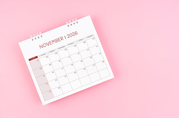 November desk calendar for 2026 year on pink background for schedule to make appointment meeting.