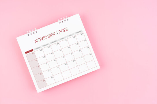 November desk calendar for 2026 year on pink background for schedule to make appointment meeting.