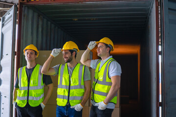 Blue collar workers are working at warehouse.