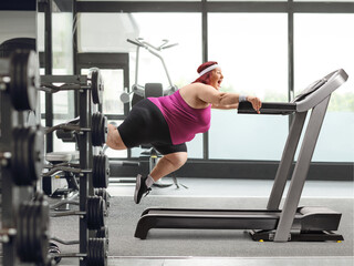 Plus size woman falling from a treadmill