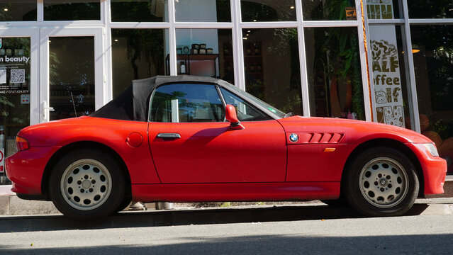 Bucharest, Romania &ndash; June 8, 2025: Closeup side view of BMW Z3 roadster red car parked on street 