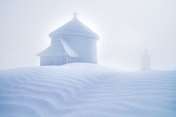 Snow-Covered Chapel in Winter Landscape